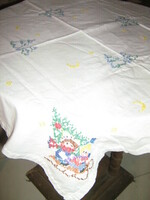 Hand-embroidered tablecloth with children sledding with a beautiful winter pine tree