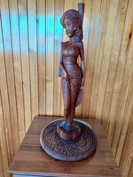 A large, heavy Indian female statue carved from wood