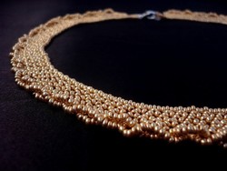 Gold colored pearl necklace