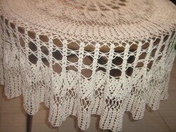 A beautiful off-white hand-crocheted round tablecloth