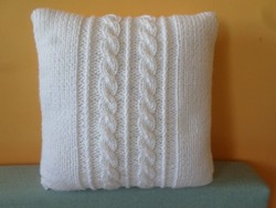 Snow-white hand-knitted decorative pillow.