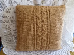 Cappuccino-colored hand-knitted decorative pillow.