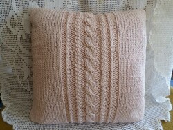 Antique pink hand-knitted throw pillow.