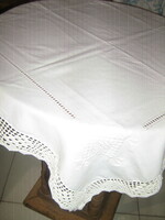 Beautiful hand-crocheted snow-white hand-embroidered azure tablecloth