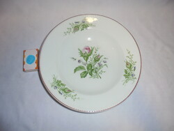 Old pink porcelain wall plate with beaded edge