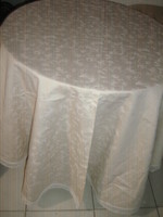 A huge floral damask tablecloth with a beautiful lace edge