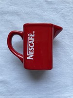 Thick red nescafé coffee milk, cream pourer