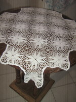 A beautiful, hand-crocheted tablecloth with a special shape