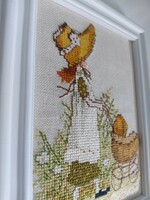 Cross stitch picture of a charming girl in a straw hat, pushing a pram, in a beautiful frame