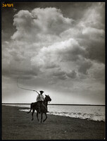 Larger size, photo art work by István Szendrő. A colt on horseback, a sled, a whip, ethnography, people