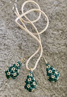 Earrings pendant made of dark green drop-shaped polished pearls on split leather thread