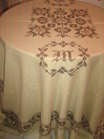 Beautiful antique hand-embroidered woven tablecloth with cross-stitch fringe