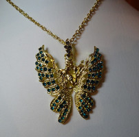 A beautiful butterfly pendant necklace with a dream inducing gentle feelings, with a couple in love in the middle.