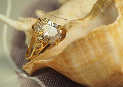 Gold-colored (goldfilled) ring with a white stone