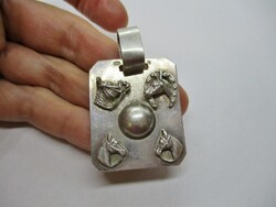 A very nice big silver pendant with a horse