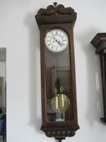 In a narrow case--double weight wall clock---video