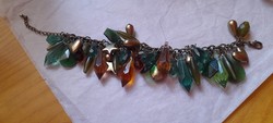 Green-gold bracelet with many pendants with a heart and star motif