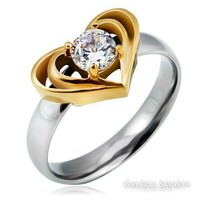 Ring made of surgical steel, two heart outline decorations, with a round, polished zirconia stone.