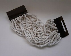 Retro fashionable bracelet made of multi-row white porcelain beads with a precious wood safe switch