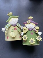 A pair of metal flowerpots with an autumn atmosphere and a scarecrow figure