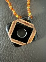 Inlaid wooden pendant on a glass bead necklace