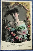 Old photo postcard of a lady with a rose