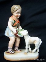 Little girl feeding a lamb