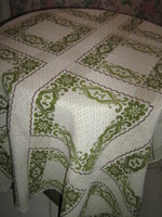 Beautiful floral woven tablecloth on a beautiful antique off-white background