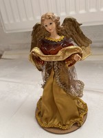A dreamy big Christmas angel in a burgundy and gold dress.