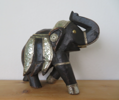 Carved wooden elephant with copper inlays