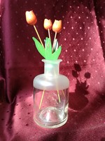 Wooden tulips in a glass vase