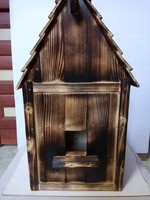 Handmade bird feeder made of burnt wood