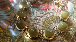 About 18 cm bracelet with olive green mineral or mineral-effect glass spheres.