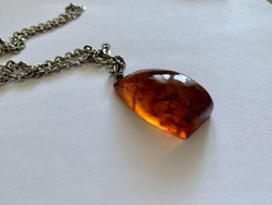 Amber pendant on a metal necklace