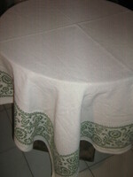 Beautiful floral woven tablecloth on a beautiful antique off-white background