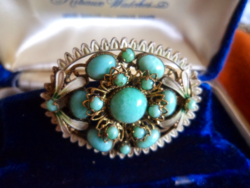 Antique filigree brooch with turquoise green stone and white enamel decoration