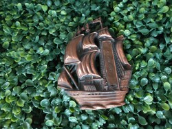 Copper, bronze-colored wall ornament depicting a sailing ship with the inscription Balatonfüred