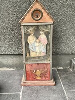 Antique homemade altar with clock and musician