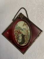 Old glass icon in a metal frame with metal decoration.