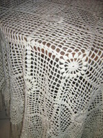 A beautiful white hand-crocheted fringe tablecloth