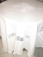 A beautiful white elegant tablecloth with a crochet insert with a hand-crocheted edge