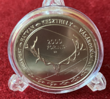 A HUF 2,000 coin of the hunting and nature world exhibition with nature