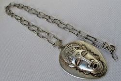 Beautiful amulet pendant on a long silver necklace