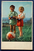 Old nostalgia photo postcard - little boys with a ball, a toy airplane