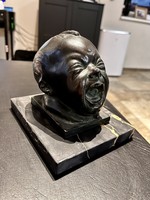 Crying baby head sculpture