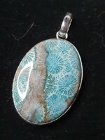 Beautiful silver pendant with a polished coral stone