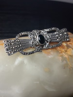 Old silver brooch with onyx stone