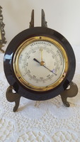 Old copper barometer with wooden frame