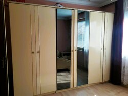 Wardrobe, bed, mirror, dresser, bedside table.