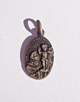 A small pendant with an old religious theme